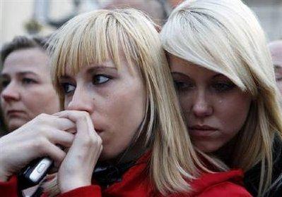 Two girls comfort each other in front of the Presidential Palace in Warsaw's city center April 12, 2010.