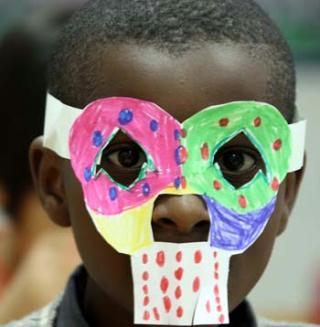 African pupil Toby wears a self-made Halloween mask at Fangcaodi International School in Beijing, Oct. 30, 2009. Pupils were getting together to celebrate the traditional Western Holiday of Halloween, which falls on Saturday. (Xinhua/Gao Xueyu)