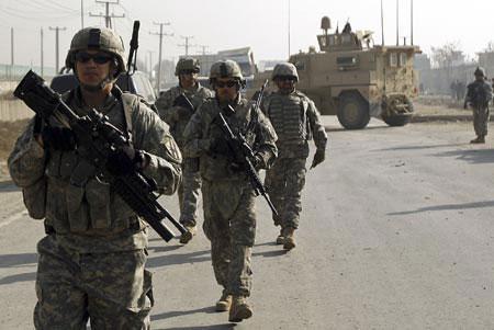 U.S. troops patrol the area after a suicide car bomb attack in Kabul November 13, 2009. A suicide car bomber struck a convoy of civilian vehicles outside a U.S. military base in Kabul early on Friday, wounding three Afghans and causing several casualties among foreigners, police said.(Xinhua/Reuters File photo)