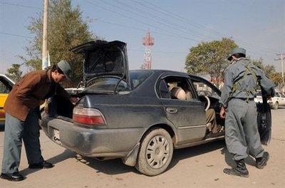 Afghan policemen search a vehicle at a checkpoint in Kabul in October 2009. Afghan and international authorities have ordered a security lockdown on Kabul to stop Taliban attacks marring Thursday's inauguration of President Hamid Karzai for another five years in power. (AFP/File/Shah Marai)