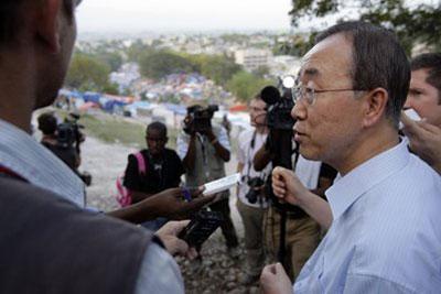 U.N. Secretary-General Ban Ki-moon, right, speaks with an NGO worker and journalists as he walks toward a makeshift camp for earthquake survivors set up at the Petionville Golf Club in Port-au-Prince, Sunday, March 14, 2010. (AP Photo/Andres Leighton)