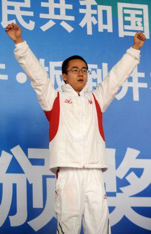 Mai Jiajie from Shanghai jubilates during the awarding ceremony for the men's 10m air pistol shooting final at the 11th Chinese National Games in Jinan, capital of east China's Shandong Province, on Oct. 20, 2009. Mai claimed the title of the event with 687.9 rings. (Xinhua/Yan Yan)