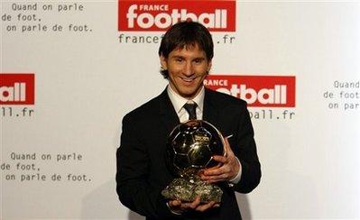 FC Barcelona's Lionel Messi, from Argentina, displays his 'Ballon d'Or' , or Golden Ball award, during a photocall, in Paris Sunday, Dec. 6, 2009. Messi received the Ballon d'Or, the prize awarded to the Europe-based footballer of the year on Sunday following an exceptional season with Barcelona.(AP Photo/Francois Mori)