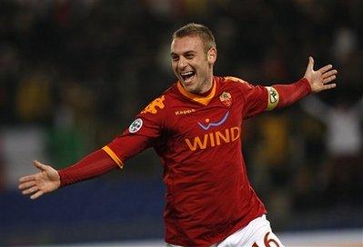 AS Roma midfielder Daniele De Rossi celebrates after scoring during an Italian Cup, quarterfinal soccer match between AS Roma and Catania at Rome's Olympic stadium, Tuesday, Jan. 26, 2010.(AP Photo/Alessandra Tarantino)