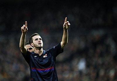 Olympique Lyon's Bosnian midfielder Miralem Pjanic celebrates after scoring against Real Madrid during their UEFA Champions League football match at the Santiago Bernabeu stadium in Madrid. Lyon won 2-1 on aggregate.(AFP/Pierre-Philippe Marcou)