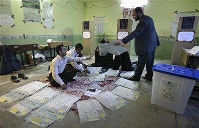 Electoral workers start the process of sorting and counting the ballot papers for the parliamentary elections at a polling station in Karbala, Iraq, Sunday, March 7, 2010. Polls have closed in Iraq's parliamentary elections after a spate of attacks that marred the vote and left 31 people dead, despite tight security. (AP Photo/Ahmed al-Hussainey) 