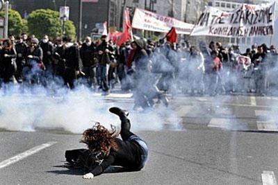 A demonstrator stumbles and falls during clashes with riot police in Athens. (AFP/Aris Messinis)