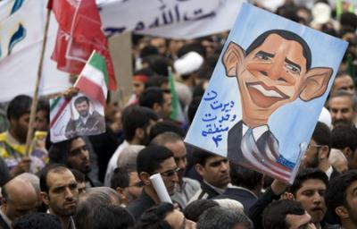 Iranian students hold a caricature of US President Barack Obama during a rally outside the former US embassy in Tehran November 4, 2009. [Agencies]