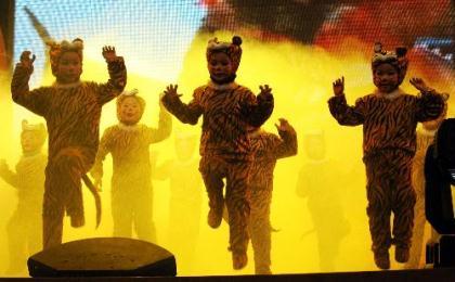 Kids in tiger-shaped costumes perform their tiger dance at a party organised by Bozhou Electricity Supply Company in Bozhou, east China's Anhui Province, Jan. 26, 2010. The party was held for welcoming the Chinese traditional Spring Festival, or the Chinese lunar new year of tiger. (Xinhua/Zhang Yanlin)