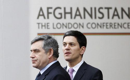 Britain's Prime Minister Gordon Brown (L) and Afghanistan's President Hamid Karzai (not pictured) are greeted by Foreign Secretary David Miliband at the "Afghanistan: The London Conference", in London January 28, 2010. (Xinhua/Reuters Photo)