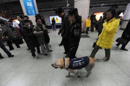 A policewoman patrols a subway station with police dog in Beijing, capital of China, on March 30, 2010. Fu Zhenghua, director of the Beijing Public Security Bureau, confirmed the security in the capital city had been increased after the double suicide bombing in Moscow's subway Monday. (Xinhua/Shi Sisi) 