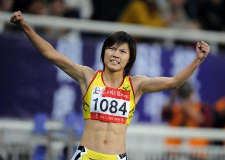 Wang Jing of Fujian Province celebrates after winning the final of women's 100m sprint at the 11th Chinese National Games in Jinan, east China's Shandong Province, October 22, 2009. [File photo:Xinhua]