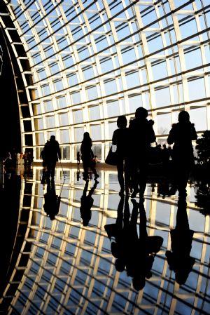 Visitors walk during the open day at the National Center for the Performing Arts (NCPA), or the National Grand Theater, in Beijing, capital of China, Dec. 22, 2009. The National Grand Theater opened to the public for free on Tuesday to mark the 2nd anniversary of its inauguration.  (Xinhua/Luo Xiaoguang)