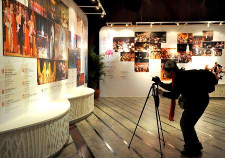 A visitor takes photos during the open day at the National Center for the Performing Arts (NCPA), or the National Grand Theater, in Beijing, capital of China, Dec. 22, 2009.  (Xinhua/Luo Xiaoguang)