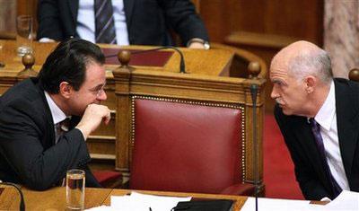 Greek Prime Minister George Papandreou, right, listens to Greek Finance Minister George Papaconstantinou during a budget debate at the Greek Parliament in Athens on Wednesday, Dec. 23, 2009.(AP Photo/Thanassis Stavrakis)