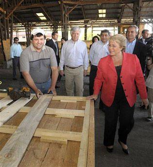 In this photo released by Chile's Presidency, President Michelle Bachelet visits a factory of emergency houses in Santiago, Wednesday, March 3, 2010. (AP Photo/Alex Ibanez, Chile's Presidency)