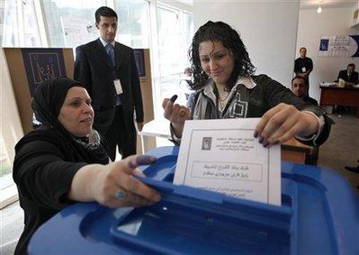 An Iraqi woman, casts her vote at a polling center in Beirut, Lebanon, on Friday March 5, 2010. Iraqis living abroad have began casting ballots in their homeland's crucial parliamentary elections. The United Nations refugee agency estimates that around 2 million Iraqis are living abroad after fleeing since the 2003 U.S.-led invasion. (AP Photo/Bilal Hussein) 