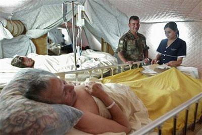 Earthquake victims lie in beds in a field hospital in Talca, Chile, Wednesday, March 3, 2010. (AP Photo/ Cristobal Fuentes)