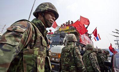 Thai soldiers check anti-government demonstrators for weapons and other items at a checkpoint in Wang Noi, Thailand, Saturday, March 13, 2010. (AP Photo/David Longstreath)