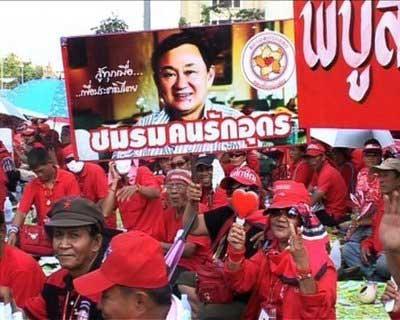 Tens of thousands of red-shirted supporters of deposed Thai premier Thaksin Shinawatra gathered in Bangkok on Sunday to demand that the government step down. (AFP)