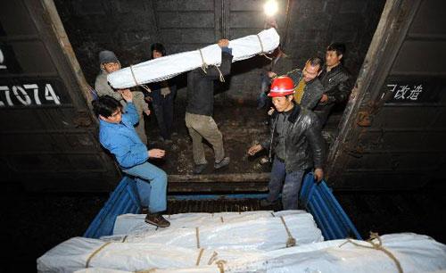 Workers load tents onto a train at the Hefei Railway Station in Hefei, capital of east China's Anhui Province, April 14, 2010. (Xinhua/Guo Chen)