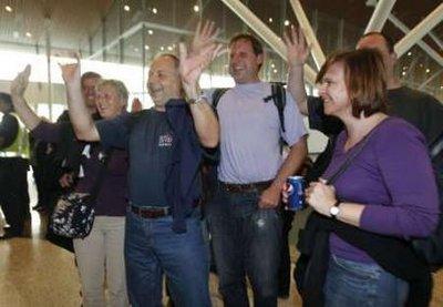 Passengers of Malaysia Airline System's MH0001S gesture to journalists as they arrive from Frankfurt at Kuala Lumpur International Airport outside Kuala Lumpur April 21, 2010. The Malaysia airline's on Wednesday flew 338 stranded passengers from Frankfurt into the Kuala Lumpur's airport. The national carrier was the first carrier of ASEAN countries to operate flights out of Frankfurt. Europe's skies were opened for business on Wednesday, but with so many planes having been grounded by the pall of volcanic ash spreading from Iceland it could take days, or weeks, to clear the backlog.REUTERS/Bazuki Muhammad