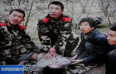 Screen grab from Chinese state CCTV shows military personnel attempting to save a life following a major earthquake in Yushu County, northwest  Qinghai province. 
