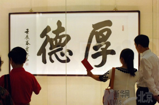 參觀者在觀看用行楷書寫的“北京精神”之“厚德”。（８月１４日攝） 新華社記者趙琬微攝
