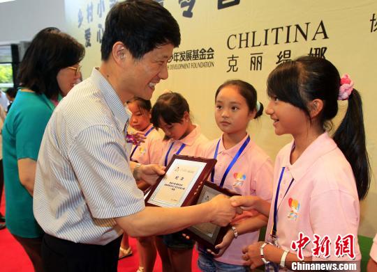 上海市臺辦副主任瞿國樑向獲獎小學生頒獎。　潘索菲　攝