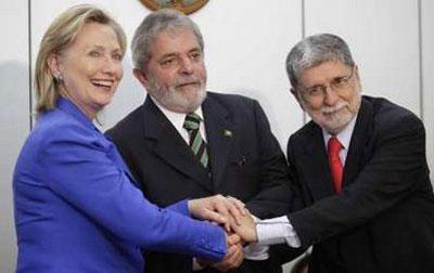 U.S. Secretary of State Hillary Clinton (L), Brazil's President Luiz Inacio Lula da Silva (C) and Brazil's Foreign Minister Celso Amorim shake hands during a meeting in Brasilia March 3, 2010. REUTERS/Ricardo Moraes