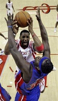 Houston Rockets' Tracy McGrady (3) is fouled by Detroit Pistons' Kwame Brown (38 ) during the first quarter of an NBA basketball game Tuesday, Dec. 15, 2009 in Houston.(AP Photo/David J. Phillip)