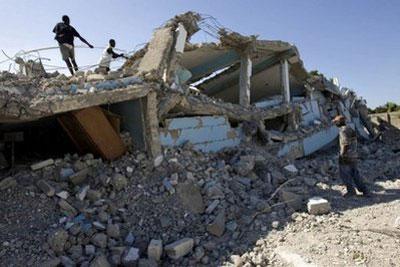 People rummage through a quake-smashed school in Cite Soleil in Haiti on January 12. (AFP/HO/UN/MINUSTAH/File/Logan Abassi)