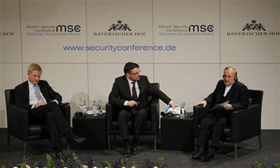 Iranian Foreign Minister Manouchehr Mottaki, right, and Carl Bildt, Minister of Foreign Affairs of Sweden, left, are seen during the annual Munich Security conference in Munich, southern Germany, on Friday, Feb. 5, 2010. Center is moderator Stefan Kornelius. (AP Photo/Matthias Schrader)