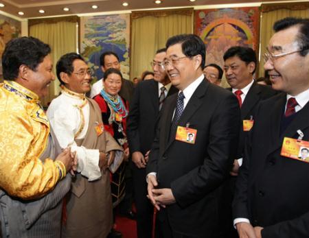 Chinese President Hu Jintao (2nd R, front) talks with deputies to the Third Session of the 11th National People's Congress (NPC) from west China's Tibet Autonomous Region, in Beijing, capital of China, March 6, 2010. Hu Jintao joined in the panel discussion of the delegation on Saturday. (Xinhua)