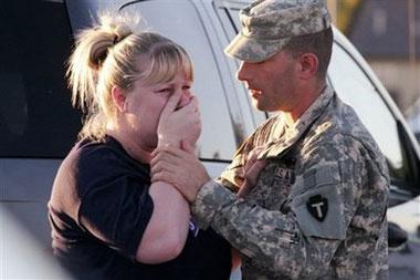 Sgt. Anthony Sills, right, comforts his wife as they wait outside the Fort Hood Army Base near Killeen, Texas on Thursday, Nov. 5, 2009.(AP Photo/Jack Plunkett)