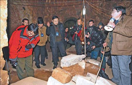 Archaeologists inspect a recently unearthed tomb in Anyang, Henan province, on Monday. The local archeological administration believes the mausoleum belongs to ancient warlord Cao Cao (AD 155 to 220).[Wang Yongji/China Daily]