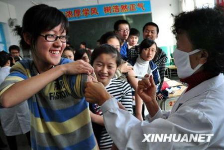 Students receives the A/H1N1 influenza vaccination in Mudanjiang, a city in north China's Heilongjiang province, Oct. 28, 2009. A vaccination program against the A/H1N1 virus is kicked off in the autonomous region on Wednesday. (Xinhua/Huang Xiaobang)