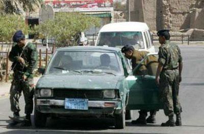 Yemeni police troopers search cars at the gate of Sanaa International Airport January 19, 2010. REUTERS/Khaled Abdullah