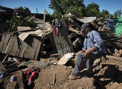 Earthquake victim Jose Cerda, 83, enters in his destroyed house in Parral, Chile, Monday, March 15, 2010. An 8.8-magnitude earthquake hit central Chile last Feb. 27, causing widespread damage. (AP Photo/Martin Mejia) 