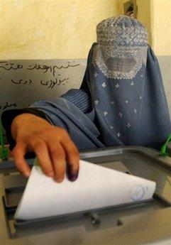 An Afghan woman casts her ballot at a polling station in Kabul. Fraud investigation into Afghanistan's elections have cut President Hamid Karzai's share of the vote to 48 percent, below the threshold for outright victory, according to a US election monitor.(AFP/File/Massoud Hossaini) 