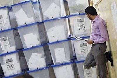 An Iraqi member of the Independent High Electoral Commission (IHEC) counts ballot boxes stored at the IHEC's headquarters in Baghdad. (AFP/Ahmad al-Rubaye)