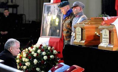 Poland's former Prime Minister Jaroslaw Kaczynski, and twin brother of the late President Lech Kaczynski, kneels before the coffins of his brother and first lady Maria Kaczynska during a service at the Warsaw Cathedral,in Poland, Saturday, April 17, 2010. (AP Photo/Ludmila Mitregai)