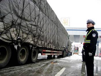 Traffic policemen help vehicles pass the toll station of Bantangdao Entry of the reopened Hefei-Chaohu-Wuhu Expressway, Chaohu, east China's Anhui Province, Jan. 29, 2008. Over 2,000 vehicles were suspended in Chaohu due to the heavy snow in the past few days. (Xinhua Photo)