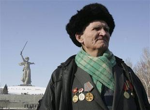 A World War II veteran stands in front of a giant statue of 'Mother of the Homeland,' a part of the memorial on Mamayev Hill built to honor those who died during the Battle of Stalingrad during World War II, in Volgograd, Russia, Saturday, Feb. 2, 2008. (AP Photo/Sergei Karpukhin, Pool)