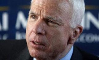 Republican presidential candidate Senator John McCain speaks to reporters on his bus on his way to a campaign rally in Fairfield, Connecticut, Feb. 3, 2008. (Xinhua/Reuters Photo)