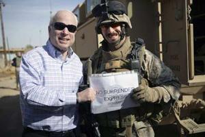 US Republican presidential candidate Senator John McCain (R-AZ) stands with Major Gordon Hilbun (R), McCain's vehicle commander in Haditha, Iraq, on March 16, 2008. Picture taken March 16, 2008. (Xinhua/Reuters Photo)