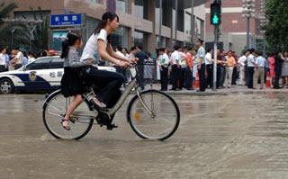 A street in Chengdu, capital of southwest China's Sichuan Province, is covered by water after a water pipe blew out during an earthquake on May 12, 2008. A major earthquake measuring 7.8 Richter Scale jolted Wenchuan County of Sichuan province at 2:28 p.m. on Monday. (Xinhua Photo)