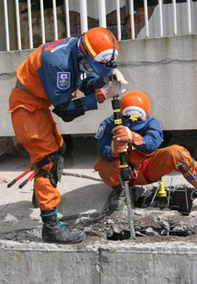 Rescuers search for buried people at a collapsed middle school in Beichuan County, southwest China's Sichuan Province, May 18, 2008. A survivor named Tang Xiong was saved from the rubble on May 18, 139 hours after being buried after the quake. (Xinhua Photo)