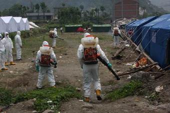 Medical workers sprays disinfectants in quake-hit Beichuan County of Mianyang City, southwest China's Sichuan Province, May 22, 2008. The Ministry of Health and local Sichuan health agencies had dispatched 73,518 workers to conduct disease prevention work in quake-hit villages in Sichuan, and no major outbreak of epidemic diseases or other public health threats have so far been reported in quake-stricken areas.(Xinhua Photo)