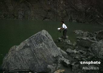 Workers are planning to dig channels to reduce the increasing water that's building up in a quake-formed lake which is in danger of bursting.